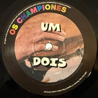 OS CHAMPIONES <br> UM DOIS TRES